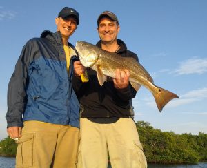 John George (L) and Mike Scheid showing off their redfish caught on a CAL jig with a Shad tail.
